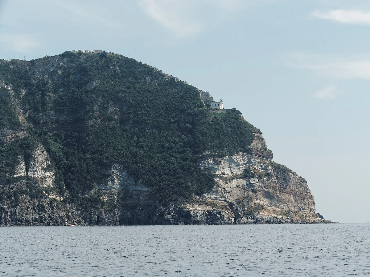 Punta Imperatore lighthouse on the west headland of Ischia passed by the Alcione boat excursion with lunch on board, Campania, Italy