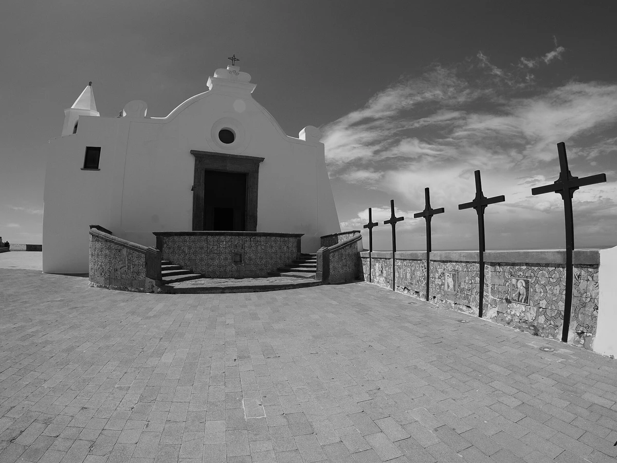 White Chiesa del Soccorso on its tuff promontory above the port of Forio, departure landmark of the Ischia island boat tour with lunch, Campania, Italy